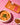 Butter chicken in a bowl with a packet labeled 'butter chicken' on a pink checkered background